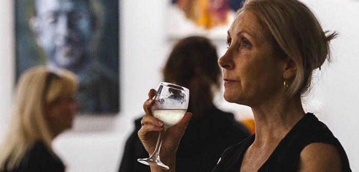 Campbelltown Toursim, women drinking wine while browsing art exhibition