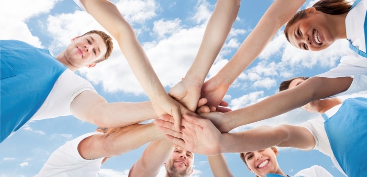 Group of people with hands piled