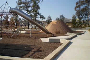 The playground features climbing frames, slides and rock climbing wall