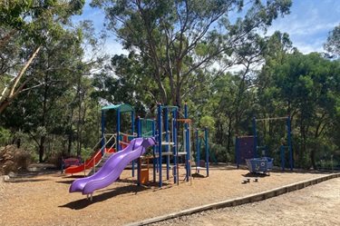 Kids can have fun on the playground while parents relax at a table