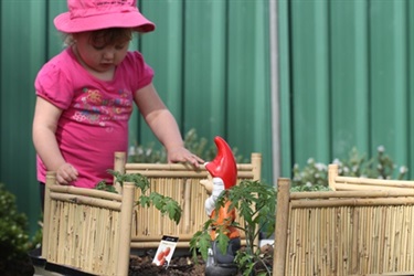 Children with a pot of clay