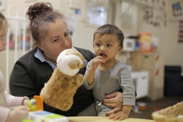 Educator and child with puppet