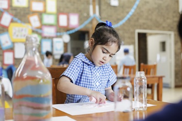 Girl drawing with chalk