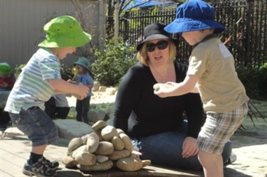 An educator with children outdoors