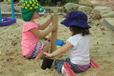 two girls in sandpit