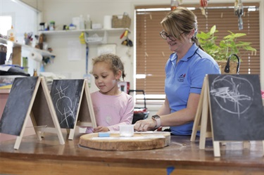 Girl drawing on chalkboard