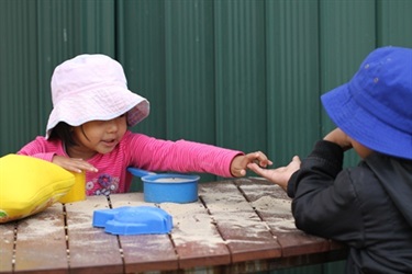 Children playing on outdoor table