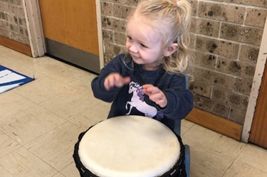Child playing the drum