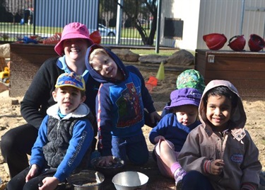 Educator and children in the sandpit