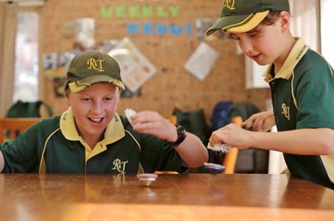 Two boys enjoying top spinning game