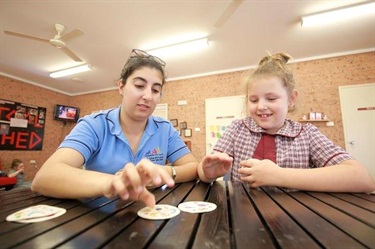 Educator and child playing card game