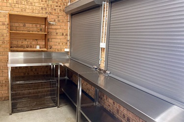 Canteen features stainless steel benches and storage shelving