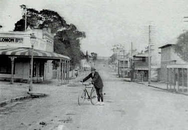 F W Wilkinson poses in 1928 next to Solomon Bros AKA Marlow's store.