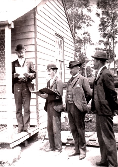 Old photograph of officials at the first polling day