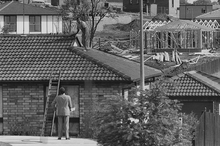 Victor Konemann on the roof of his new home in Ambarvale