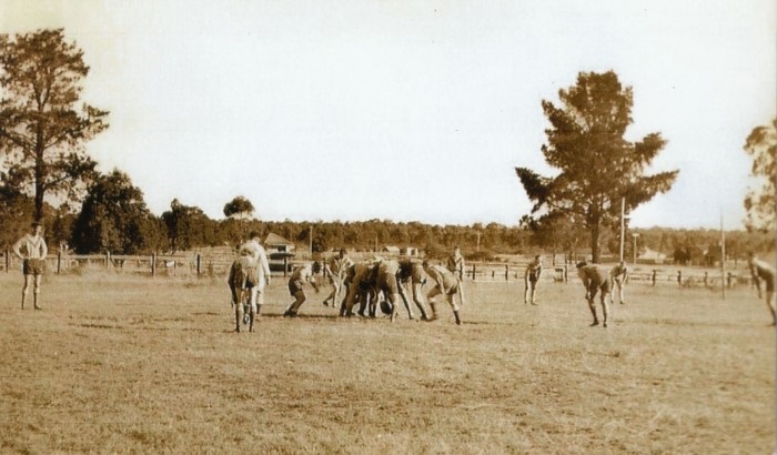 Foot ball being played on an oval 