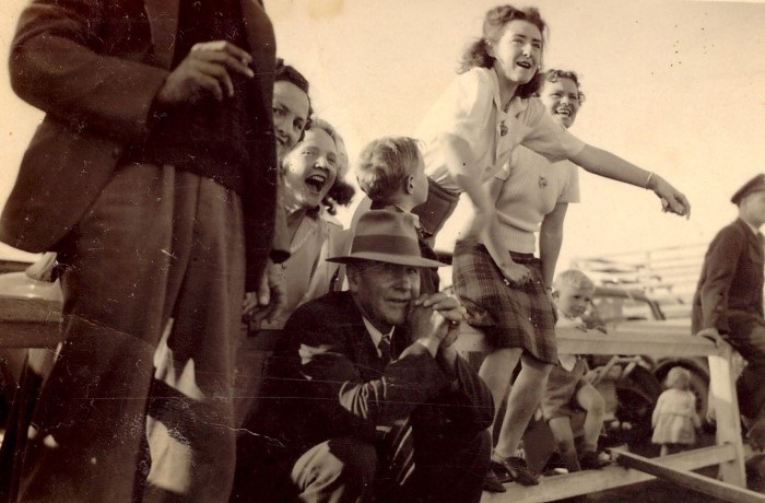 Old photograph of girls cheering on a team