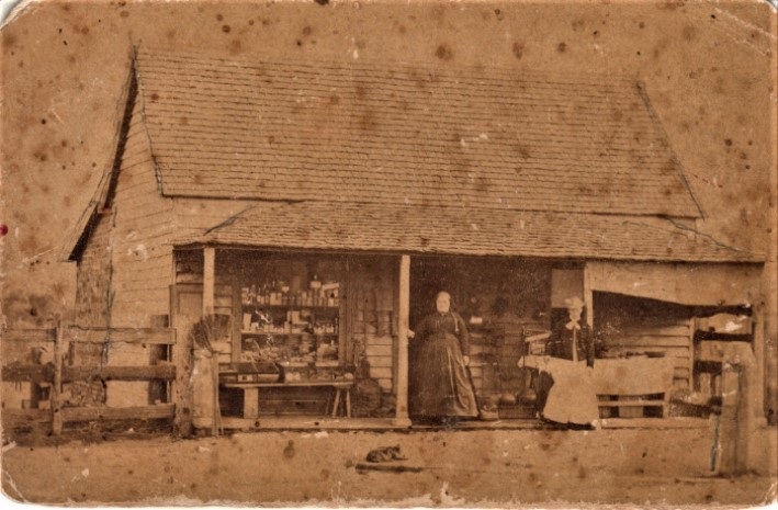 A parade passing by colonial buildings in the 1870s