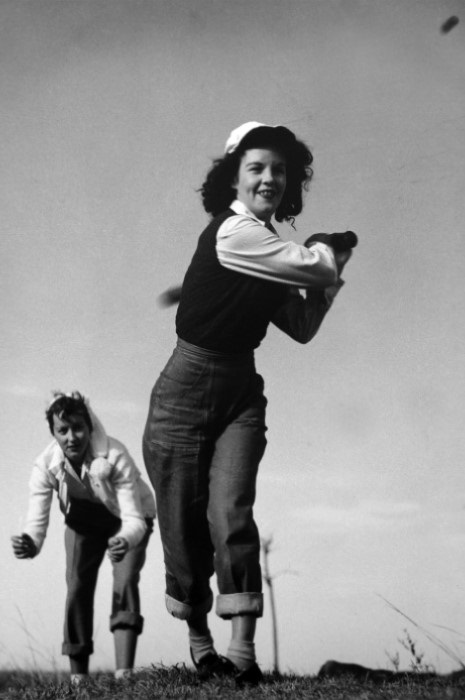 two young woman playing baseball in the 1950s