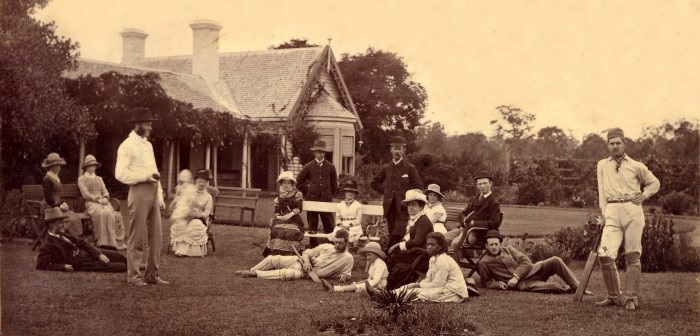 Colonial family having tea on the lawn