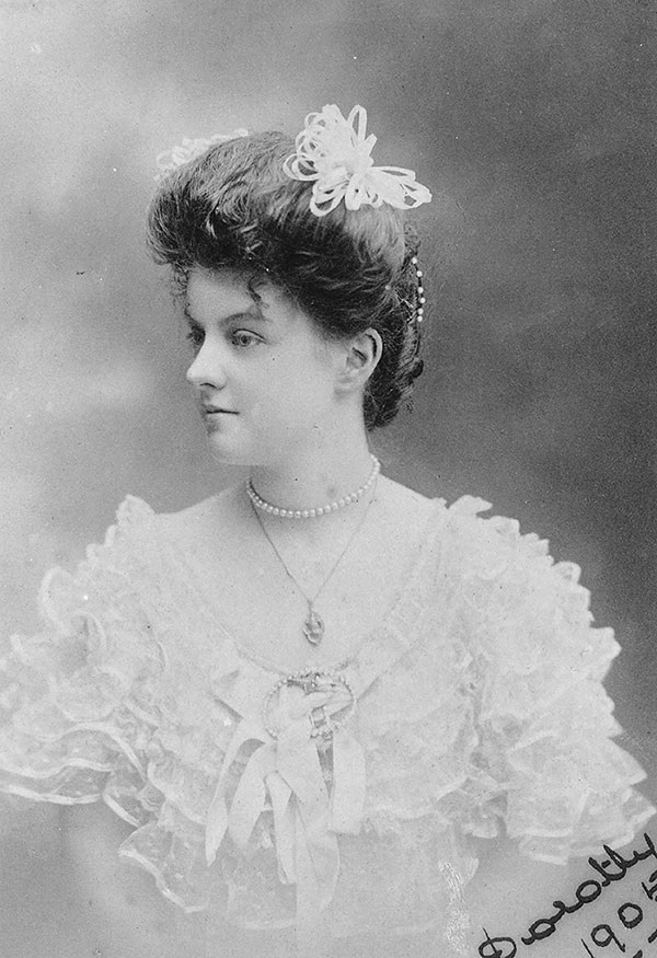 an old photograph of a young lady wearing the typical fashion of the day in the 1900s