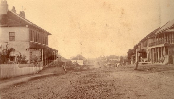 Sepia photo of the main street of Campbelltown with dirt road and georgian style buildings