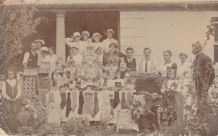 Old photograph of people helping out at a fundraising event for soldiers 