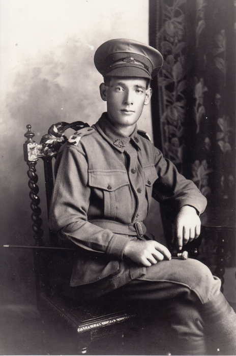 A portrait of a young soldier sitting in a chair 