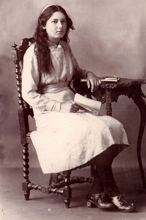 A formal looking photograph of a young lady in 1910