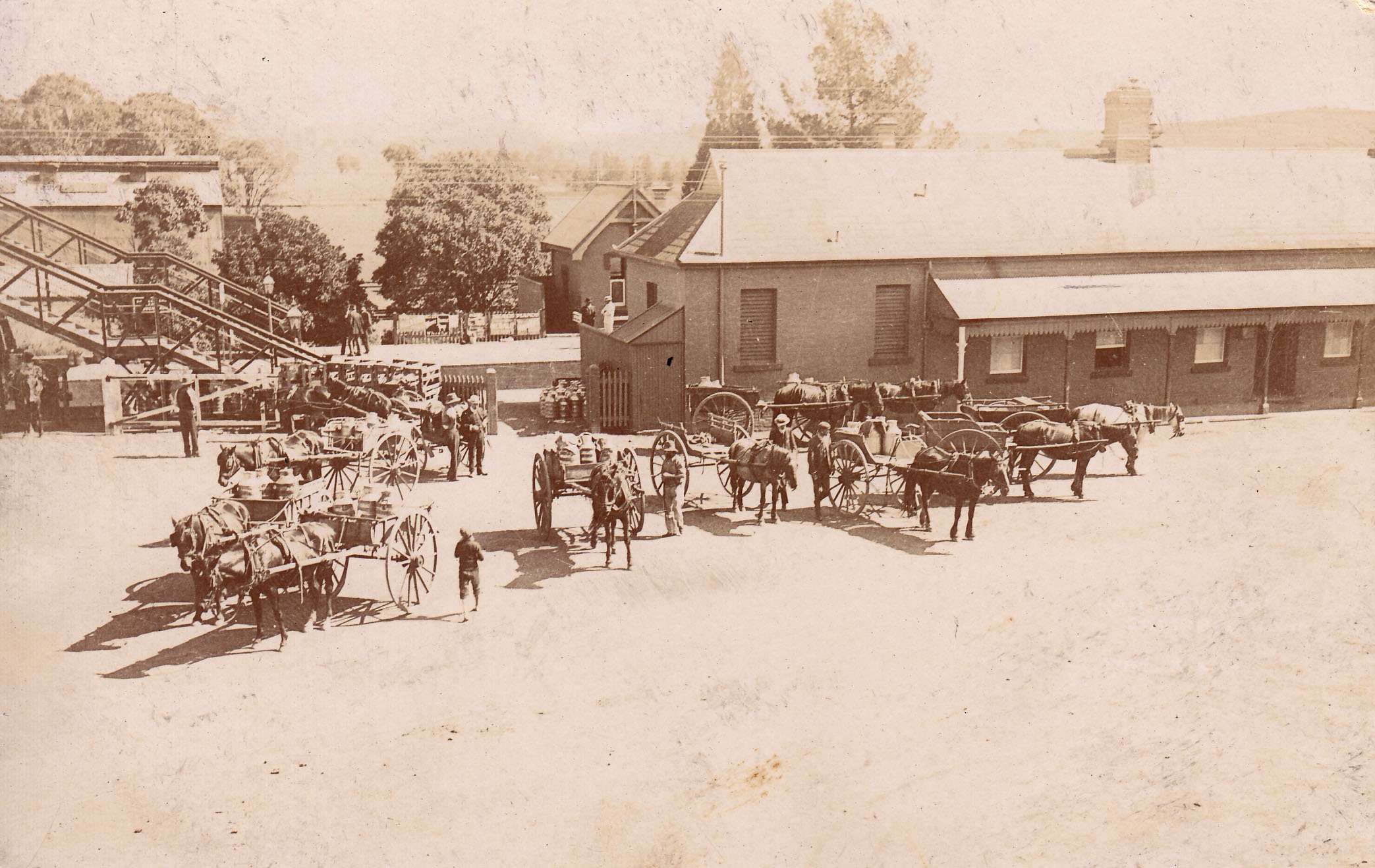 Old photograph of dairy famers waiting outside the Campbelltown Railway station
