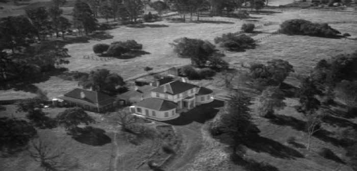 Historical black and white image of Denham Court House and surrounding property