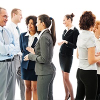 A group of male and female business people talking to each other