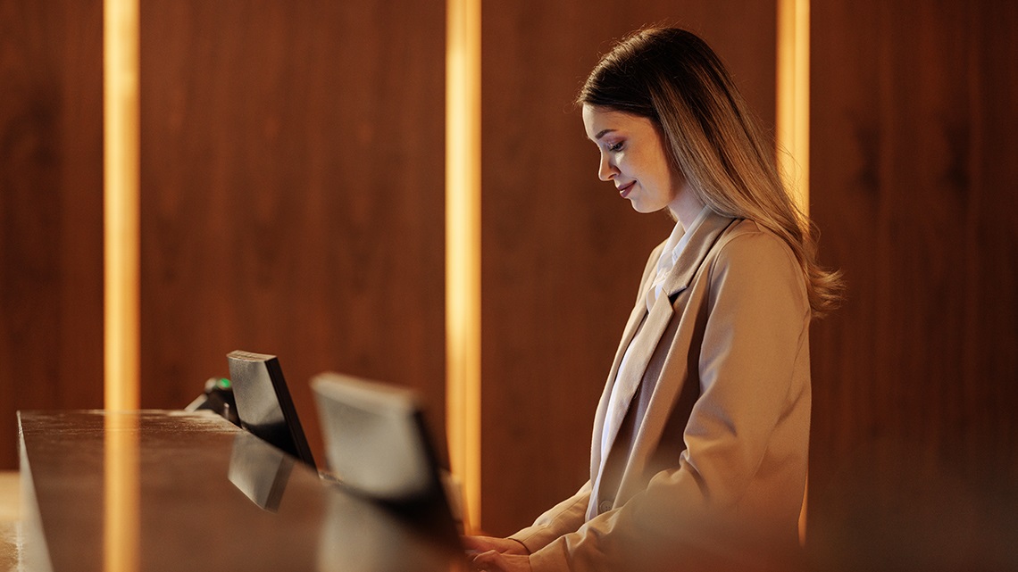 A female staff member at the front desk of a venue