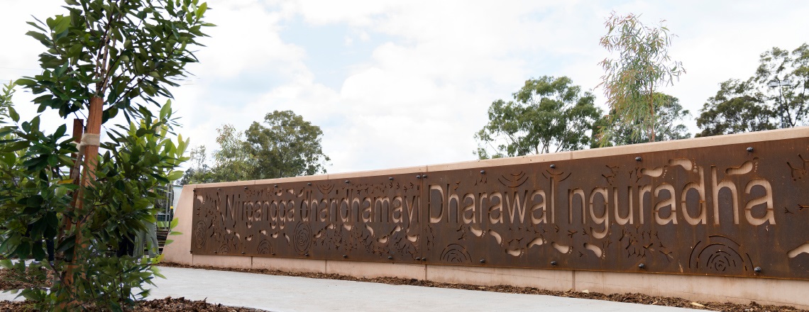 Picture of Billabong entry sign with Aboriginal artwork and name