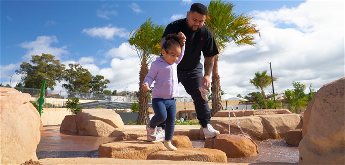 A father and daughter play in the Billabong Parklands