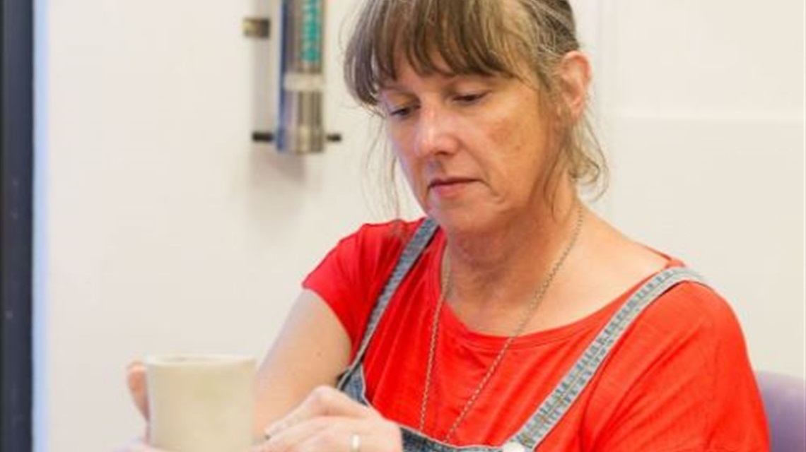 A lady participating in a ceramics class