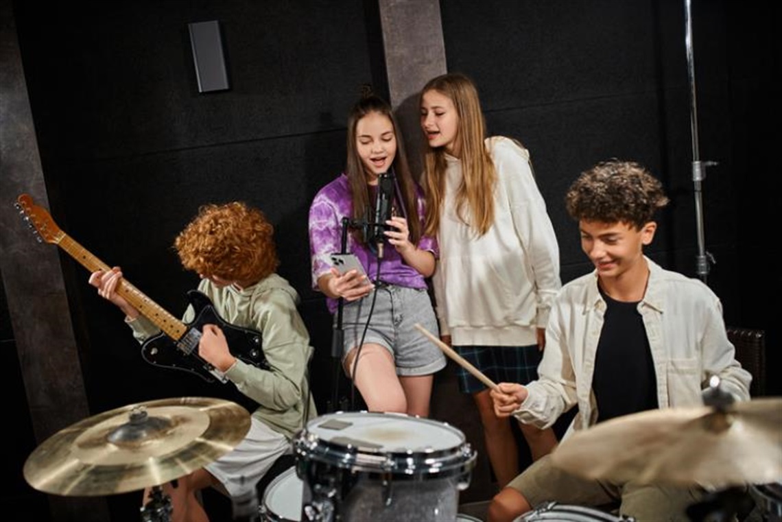 Teenagers performing in a band.