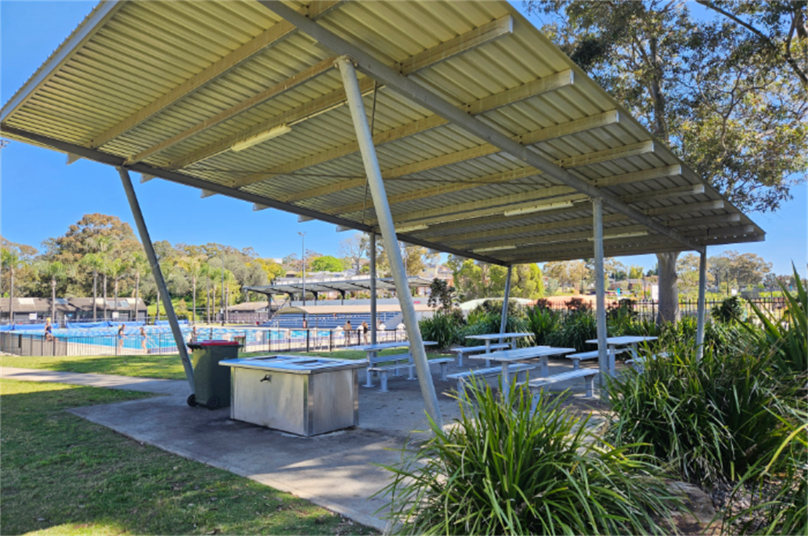 Outdoor hut with benches, tables and BBQs