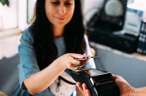 Woman using eftpos terminal