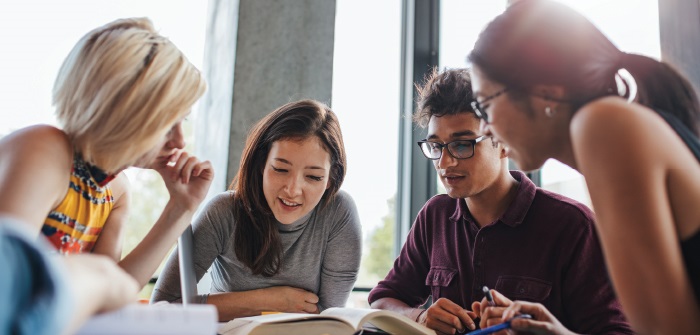 Four students studying at the library