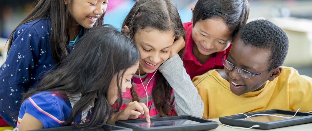 Children browsing library resources on an ipad