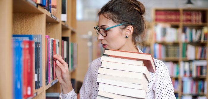 Person browsing books in the library