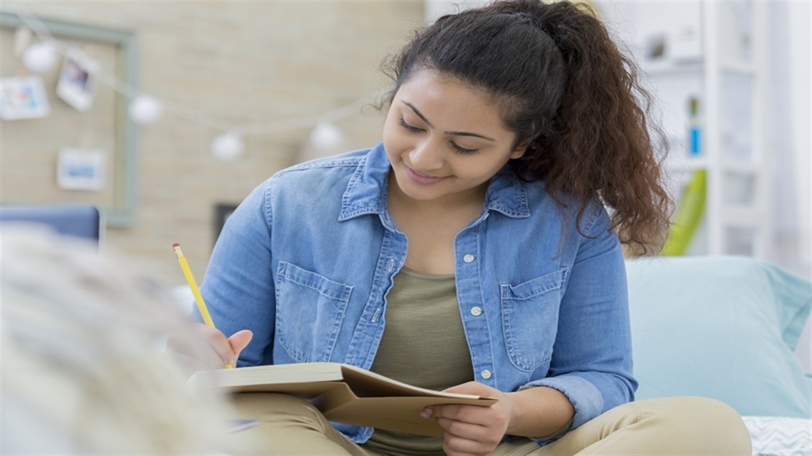 Woman writing in book