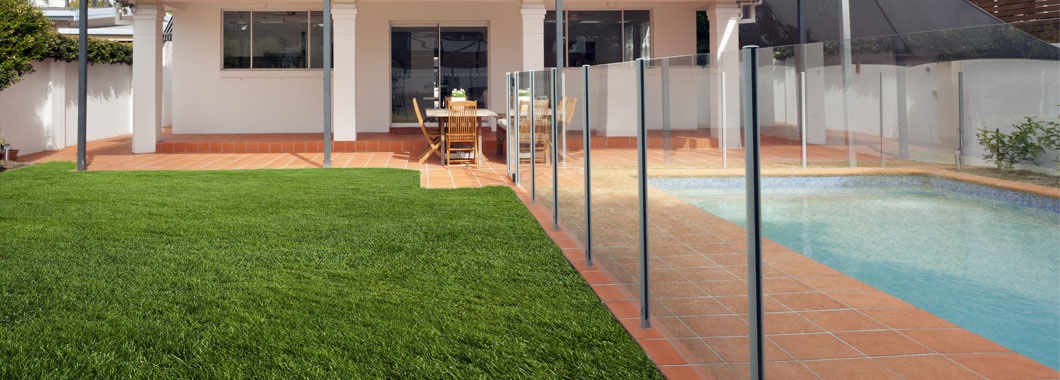 Backyard swimming pool with glass fencing