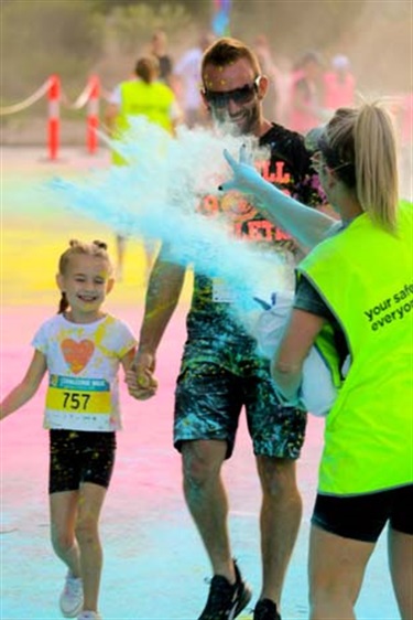 Father and daughter being colour blasted